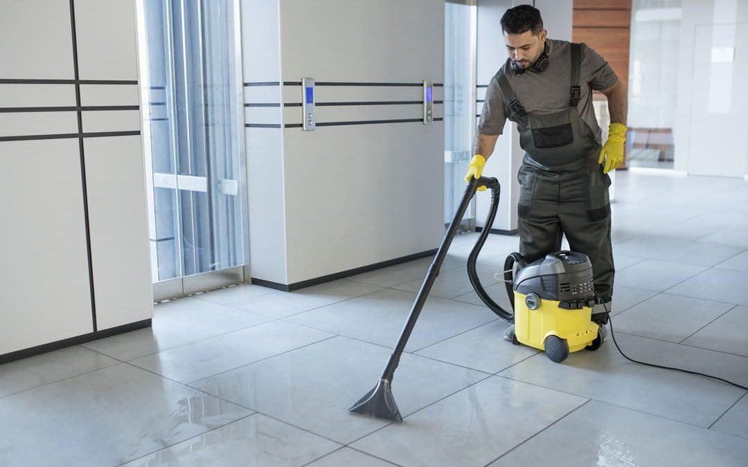 Profissional de limpeza utilizando lavadora de piso em área interna de shopping, reforçando a importância da higienização em espaços comerciais.